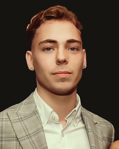 Portrait headshot of a person wearing a light checked blazer and shirt