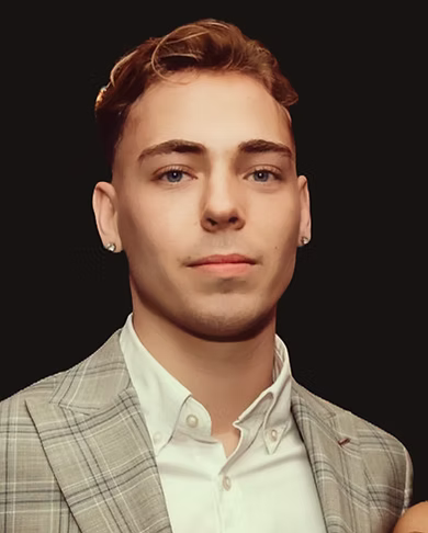 Portrait headshot of a person wearing a light checked blazer and shirt