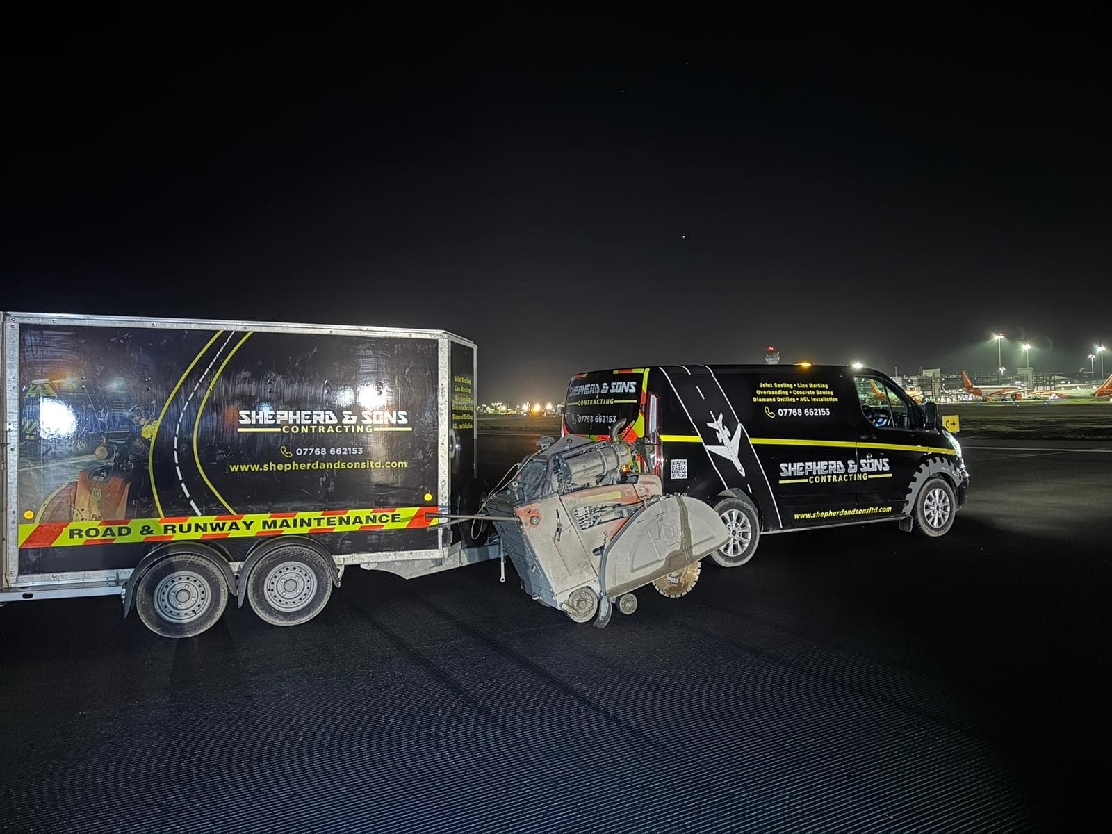 Shepherd and Sons Contracting branded trailer, floor saw and van on grooved tarmac at night